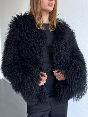 A model showcases a luxurious black fluffy coat with voluminous sleeves, exuding elegance and warmth, perfect for winter. MEOTINE.