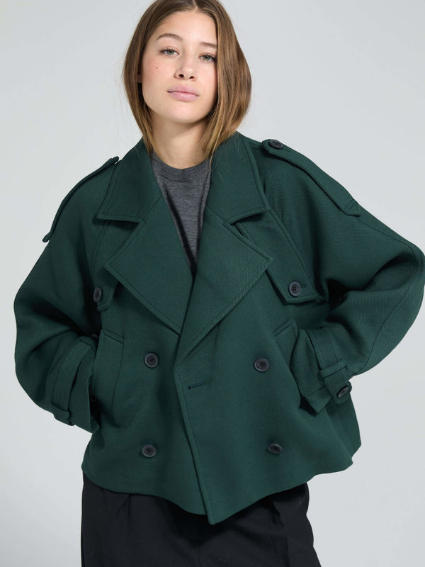 A model wears a stylish oversized green double-breasted coat by MEOTINE, featuring large buttons and a relaxed fit.