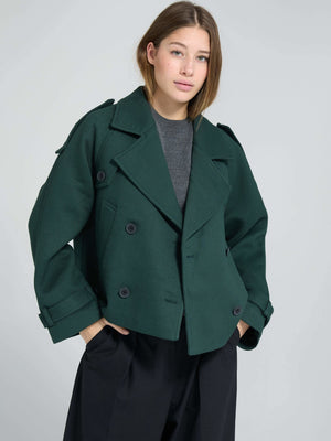A model showcases a stylish green double-breasted coat with a relaxed fit, perfect for a chic look by MEOTINE.