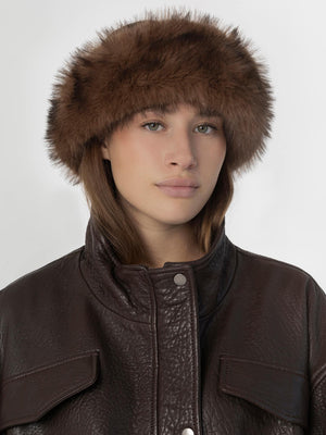 A model wearing a brown fur hat paired with a stylish leather jacket, showcasing MEOTINE's chic winter fashion.