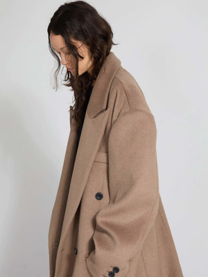 Oversized brown coat with a classic collar and button details, showcasing a relaxed fit, perfect for a stylish look by MEOTINE.