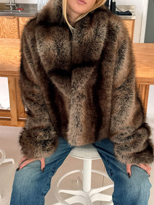Luxurious brown faux fur coat by MEOTINE, featuring a cozy oversized fit, styled with casual jeans for a chic look.