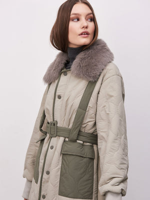 A stylish quilted coat featuring a faux fur collar, belted waist, and pockets, perfect for a chic winter look by MEOTINE.